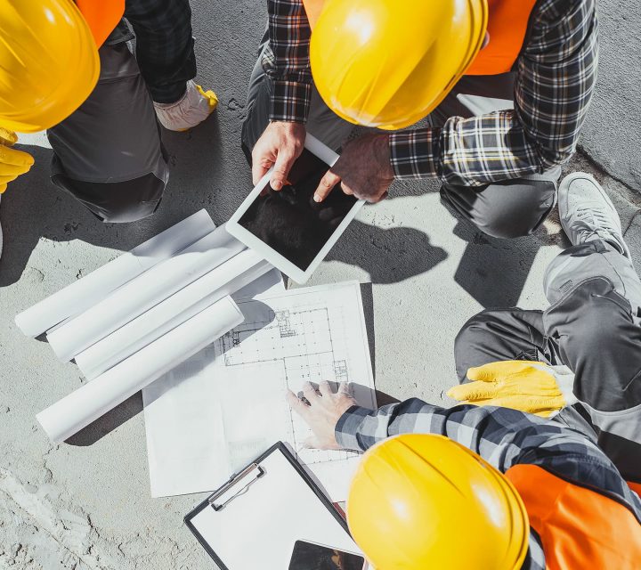 Overhead shot of construction team looking at floorplans